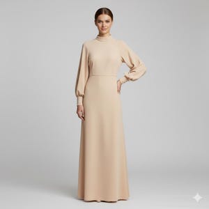 May include: A long, beige dress with a high neckline and long sleeves. The dress has a fitted bodice and a flowing skirt. The sleeves have a slight puff at the shoulder and buttoned cuffs. The dress is made of a smooth, solid fabric.