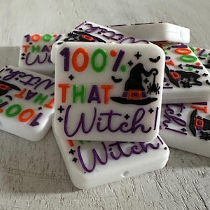 May include: White, square Halloween-themed beads with the text "100% That Witch!" in orange, green, and purple. Each bead features a witch hat and spider design. These beads are perfect for crafting.
