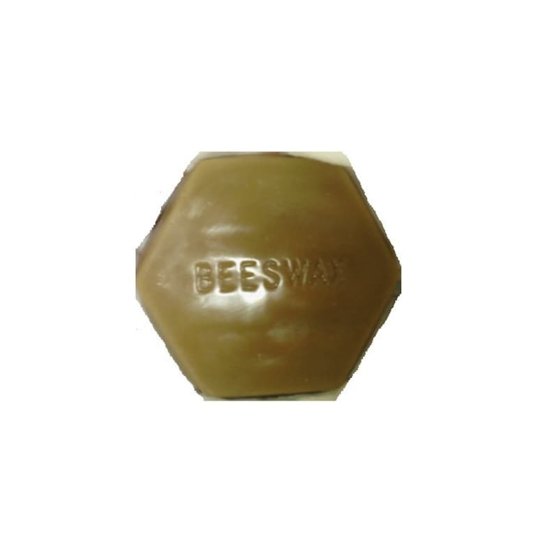 May include: A hexagonal block of beeswax in a warm, golden-brown hue. The word "BEESWAX" is embossed on the surface. The product is likely used for crafting, cosmetics, or other applications.