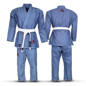 May include: A blue martial arts gi featuring a white belt tied around the waist. The jacket and pants display the StellMat logo in red and black. The back of the jacket shows a red and black triangular emblem near the collar area.