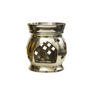 May include: A silver-coloured metal essential oil diffuser with a round body and a flared top. The diffuser features decorative cut-out designs in the shape of four-leaf clovers. The base is also flared, and the diffuser has a small opening.