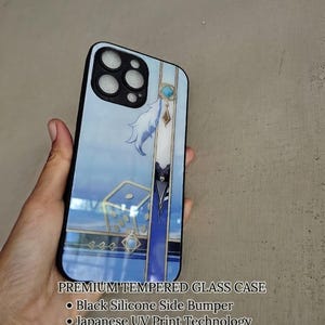 May include: A tempered glass phone case with a black silicone bumper and a glossy blue graphic print featuring a die and decorative elements. The text reads: PREMIUM TEMPERED GLASS CASE, Black Silicone Side Bumper, Japanese UV Print Technology, High-Gloss Finish, Glossy Print on Tempered Glass.