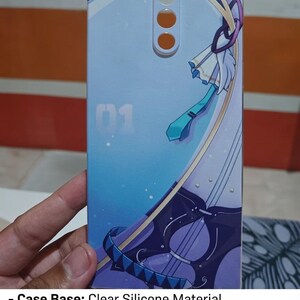 May include: A rectangular phone case with a light blue and purple anime-style graphic print. The design features the number 01, a teal necktie, and a stringed instrument. The case has circular cutouts at the top for camera and sensor components.