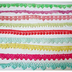 May include: Nine different trims of lace in various colors, including green, purple, pink, red, yellow, and blue. Each trim is labeled with a number from 1 to 9.