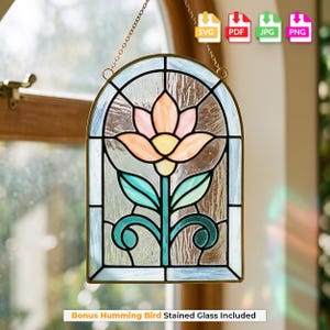 May include: An arched stained glass suncatcher featuring a central peach and yellow flower with teal leaves and stems. The glass panel is framed in metal and suspended by a chain. The design includes clear textured glass panes and a metal border.