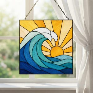 May include: A square stained glass panel featuring a large, curling ocean wave in shades of blue and teal, set against a bright yellow sun with radiating beams. The piece is suspended by a thin metal chain for hanging in a window.