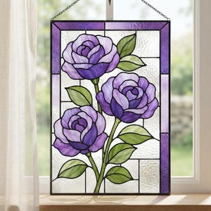 May include: A rectangular stained glass window panel featuring three purple roses with green leaves. The design is framed by a dark metal border and includes a purple glass border. The background consists of clear, textured glass panes.
