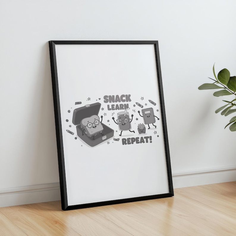 May include: Black and white framed print featuring cartoon illustrations of a sandwich in a lunchbox, a juice box, and a notebook. The text "SNACK LEARN REPEAT!" is above the illustrations. The print is displayed on a wooden floor.