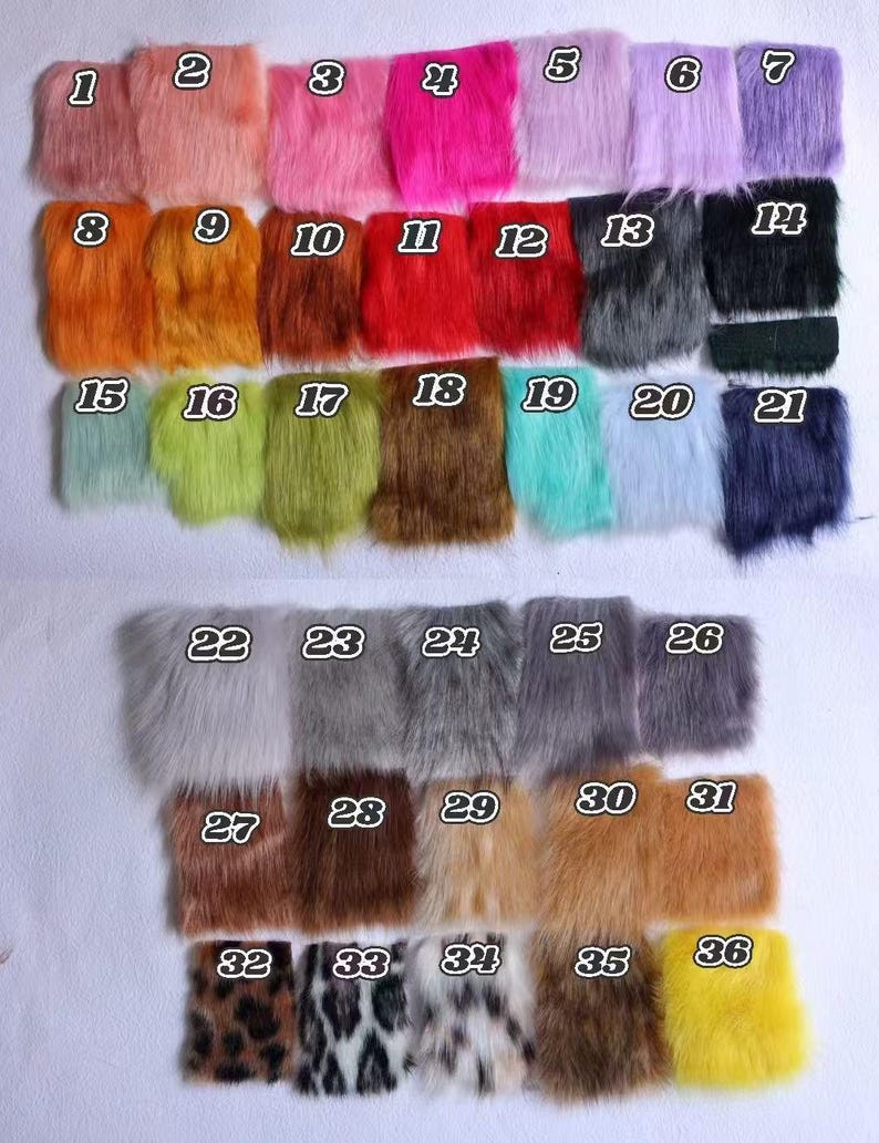 May include: A collection of thirty-six rectangular swatches of faux fur fabric arranged in a grid. Each swatch is labeled with a white number from 1 to 36 and displays a distinct color or pattern, including shades of pink, orange, red, blue, green, brown, gray, black, and animal prints.