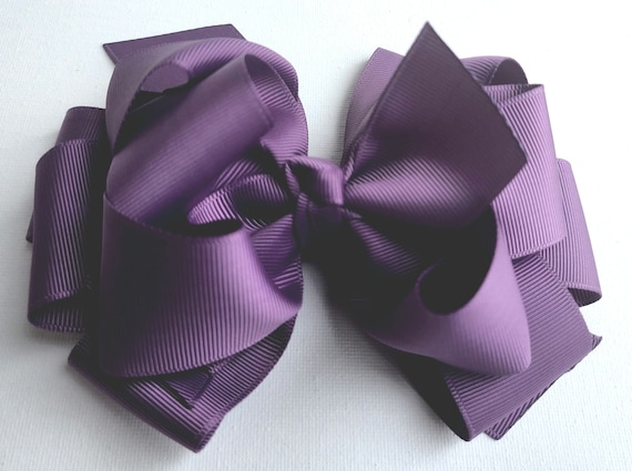 Six  inch triple layer  boutique hair bow on a hair clip. Color: Amethyst