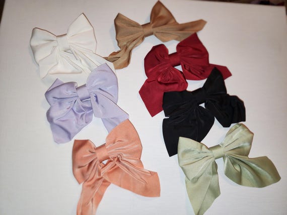 Set of seven satin coquette bows with tails on a barrette