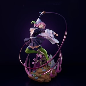 May include: A dynamic figurine of a character in a fighting pose, wielding a sword. The figure is dressed in a black and white outfit with green accents, pink hair, and green socks. The base features rocks and pink floral details, with a purple energy effect.