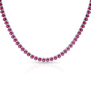 May include: A silver necklace with a string of bright red gemstones. The gemstones are set in silver. The necklace is shown against a white backdrop, accentuating the jewellery's design and the colour of the stones.