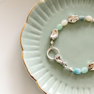 Boho Beaded Bracelet with Silver Tone Hand Pendant – Blue, White & Grey Beads