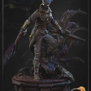 May include: A detailed figurine of a character in dark clothing, wearing a hat and mask, holding a weapon. The figure is posed on a detailed base with a dark, textured design. The overall color scheme is dark with metallic accents.