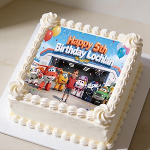 May include: A square birthday cake with white frosting and decorative piped frosting around the edges. The cake features a colorful edible image of cartoon characters and the text "Happy 5th Birthday Lochlan".