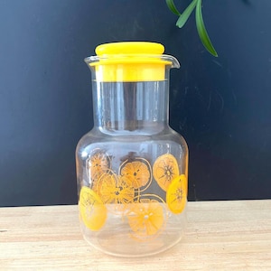 Pichet à jus Pyrex vintage en vidrio con un motivo de agrumes