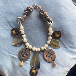 Colli Eugenie necklace in ethnic boho chic style with stone-effect pearls and tribal pendants.