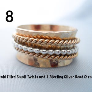 May include: A gold filled ring with two small twists and a sterling silver bead strand. The ring is hammered and has a rustic look.