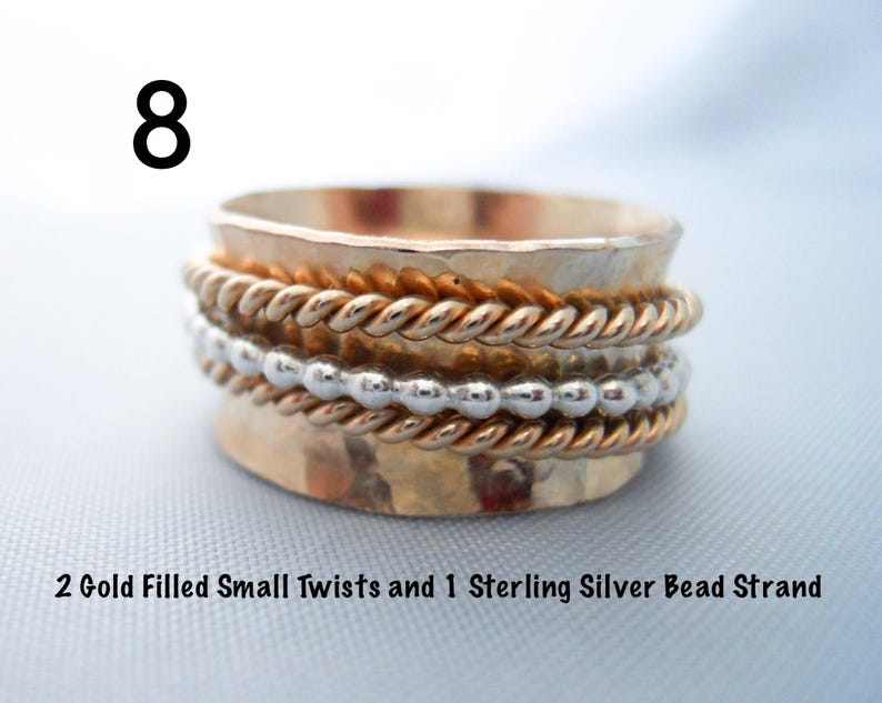 May include: A gold filled ring with two small twists and a sterling silver bead strand. The ring is hammered and has a rustic look.
