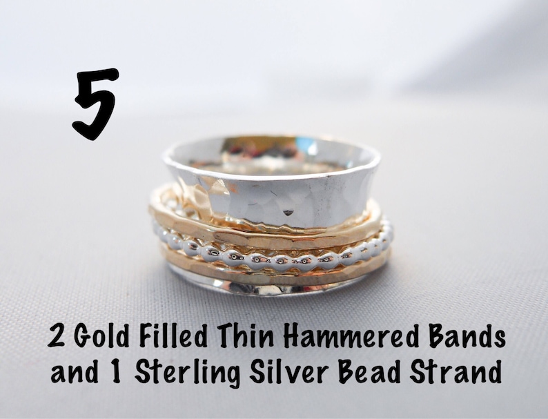 May include: A stack of three rings, two gold filled thin hammered bands and one sterling silver bead strand.