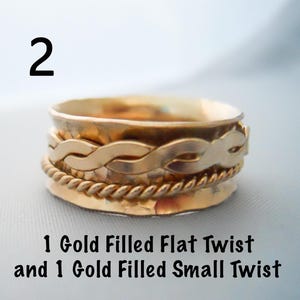 May include: Gold filled spinner ring with a flat twist and a small twist. The ring is made of two bands.