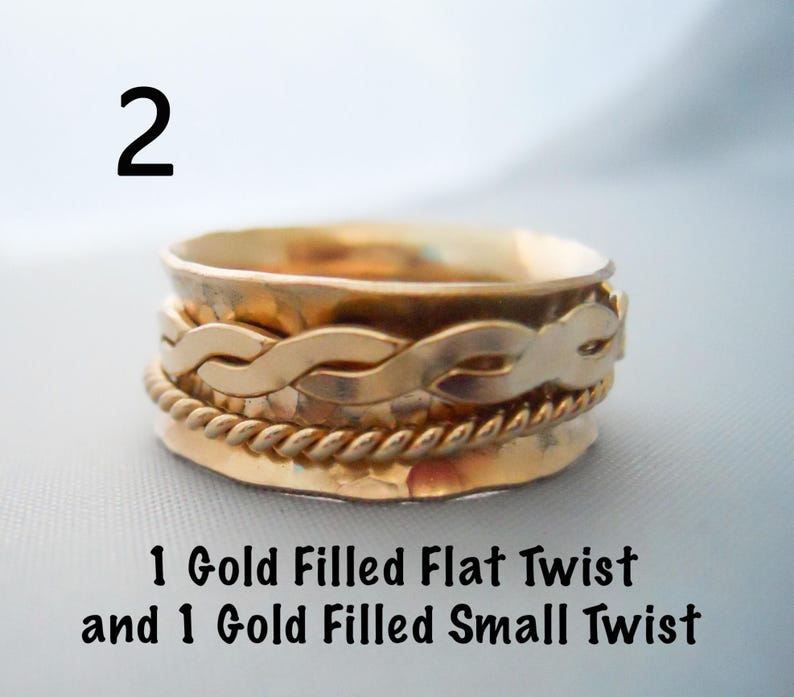 May include: Gold filled spinner ring with a flat twist and a small twist. The ring is made of two bands.