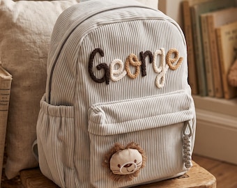 Sac à dos en velours côtelé personnalisé pour garçon avec écusson lion en relief et prénom, idéal pour les anniversaires en maternelle et en garderie.