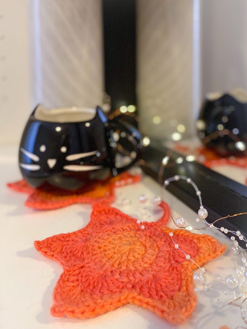 Large crochet maple leaf coaster made with ombré autumn yarn. Handmade fall home décor perfect for table settings, seasonal decorations, or as a unique crochet gift