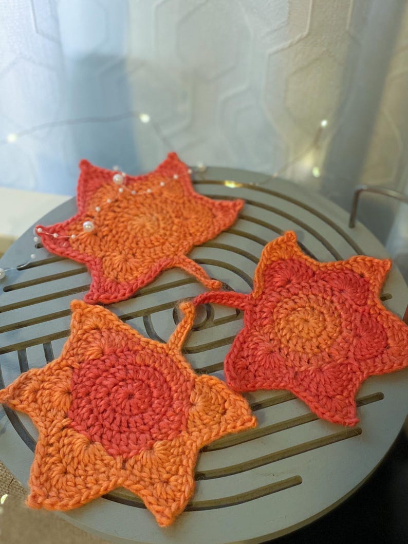 Large crochet maple leaf coaster made with ombré autumn yarn. Handmade fall home décor perfect for table settings, seasonal decorations, or as a unique crochet gift