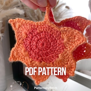 Large crochet maple leaf coaster made with ombré autumn yarn. Handmade fall home décor perfect for table settings, seasonal decorations, or as a unique crochet gift