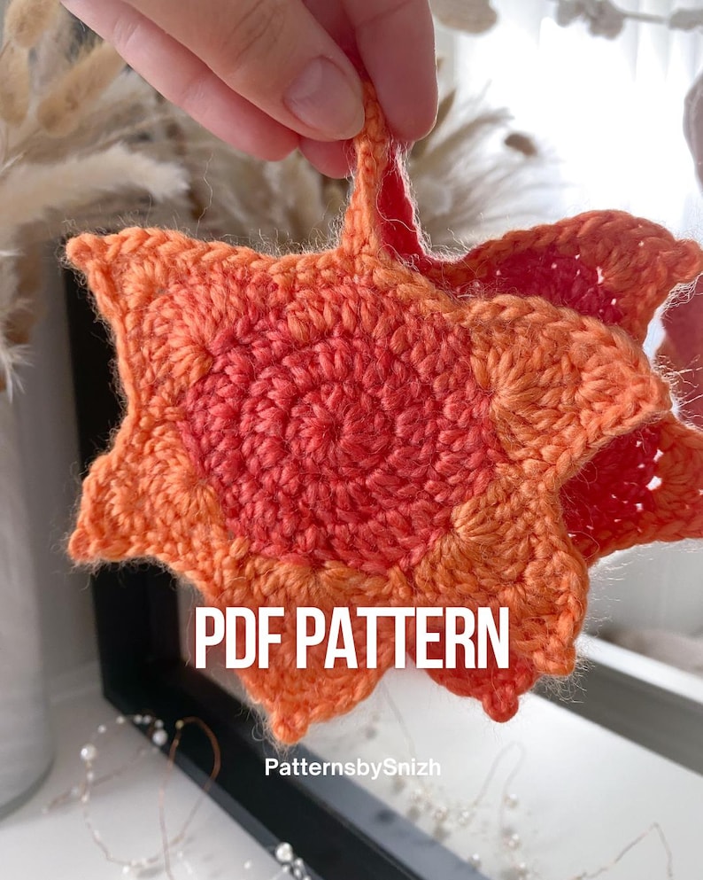 Large crochet maple leaf coaster made with ombré autumn yarn. Handmade fall home décor perfect for table settings, seasonal decorations, or as a unique crochet gift