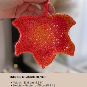 Large crochet maple leaf coaster made with ombré autumn yarn. Handmade fall home décor perfect for table settings, seasonal decorations, or as a unique crochet gift