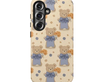 May include: A phone case with a repeating pattern of teddy bears holding bouquets of orange flowers. The bears wear blue bows and are set against a cream-colored background with small blue and orange floral accents.