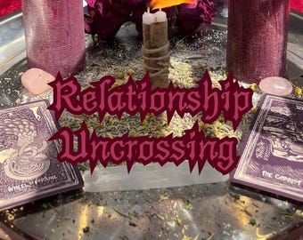 May include: A silver tray holds a lit candle, two purple candles, dried flowers, tarot cards, and crystals. The text "Relationship Uncrossing" is overlaid on the image. The tarot cards are labeled "Wheel of Fortune" and "The Chariot".