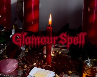 May include: A lit red candle with a flame, alongside other red candles in glass containers. A silver tray holds a pink stone, paper, and herbs. The text "Glamour Spell" is displayed in red.