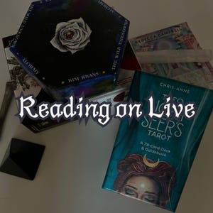 May include: An assortment of tarot decks and guidebooks, including "The Wild Unknown" and "The Seer's Tarot." The image features a black pyramid, crystals, and the text "Reading on Live."