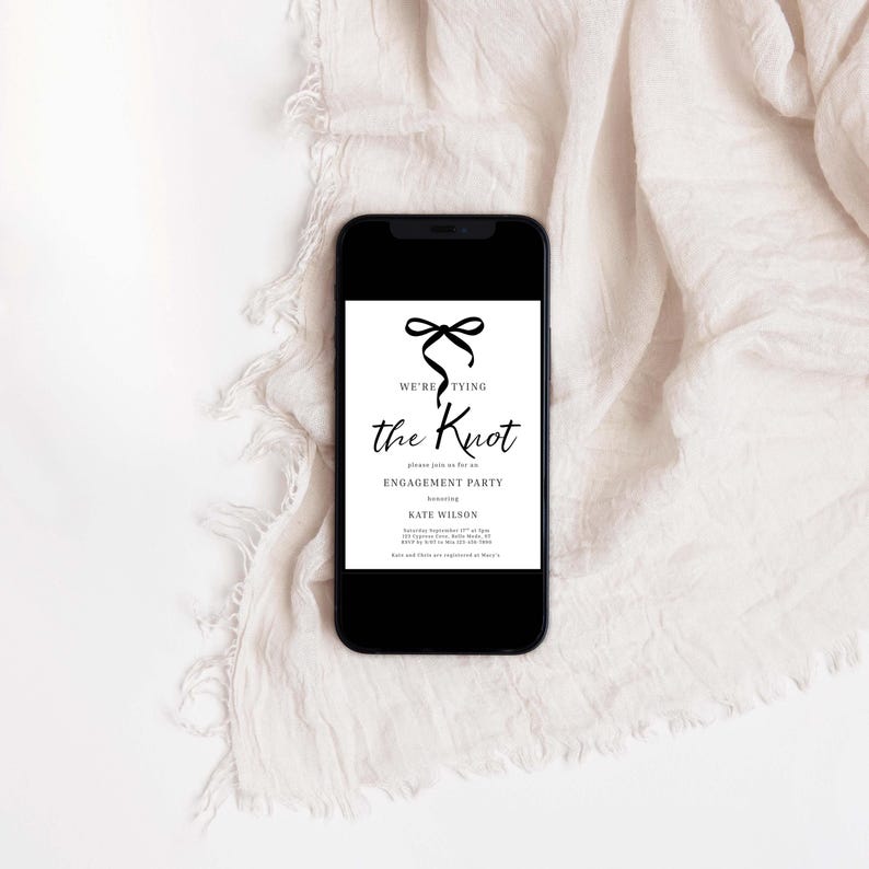 May include: A black smartphone shows a white invitation with black text and a bow graphic. The invitation reads "We're Tying the Knot" and announces an engagement party honouring Kate Wilson.