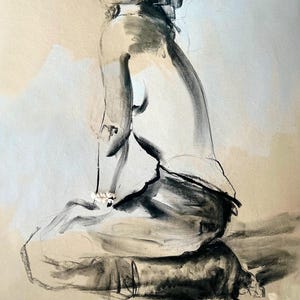 May include: A charcoal and pastel drawing of a seated figure. The artwork features a nude figure in a seated position, rendered in shades of black, white, and beige. The style is expressive, with visible brushstrokes and a focus on form and shadow.