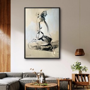 May include: Black and white abstract art print of a seated figure. The artwork is framed in a black frame and hangs on a neutral-colored wall. The art piece is a sketch-like drawing with a minimalist style.