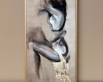May include: Abstract artwork in a gold frame. The painting depicts a figure in shades of grey, white, and black, with gold leaf texture at the bottom. The background is a neutral beige.
