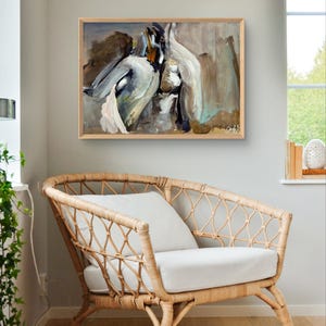 May include: Abstract painting in a wooden frame, featuring brushstrokes of white, gray, and brown. The artwork hangs above a wicker armchair with a white cushion and pillow. The room has a neutral color palette.