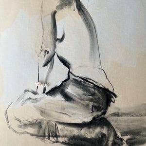 May include: A charcoal sketch of a seated figure, rendered in shades of gray and black. The artwork features bold, expressive strokes, capturing the form and posture of the subject. The figure is positioned in a seated pose, with a focus on the curves and contours of the body.