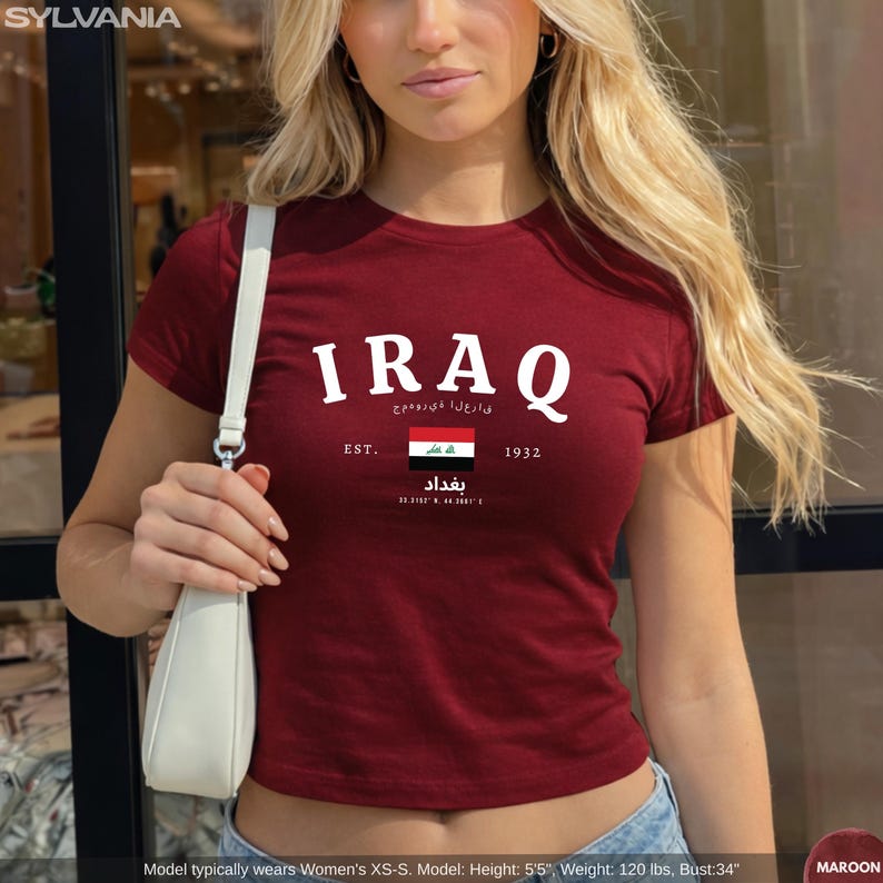 May include: Maroon crop top with the word "IRAQ" in white, along with Arabic text and the Iraqi flag. The shirt also has the text "EST. 1932" and the city name "Baghdad".