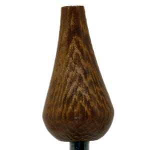 May include: A wooden bottle stopper, teardrop-shaped, with a dark brown finish and visible wood grain. The stopper is attached to a dark metal rod. The overall design is simple and elegant.