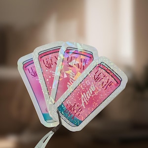 May include: A set of four holographic stickers shaped like beverage cans, featuring a pink gradient design. The text on each sticker reads "LET ME SIP MY Alani AND CIRCLE BACK" in a dark font. The stickers have a reflective, shimmering finish.