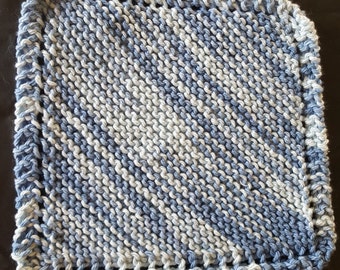 May include: A blue and white knitted dishcloth with a diagonal pattern. The dishcloth has a crocheted border.