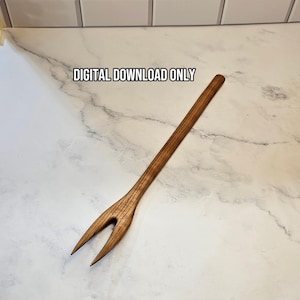 May include: A long, two-pronged wooden fork with a visible grain pattern. The text "DIGITAL DOWNLOAD ONLY" is printed in black above the fork. The utensil features a slender handle and two pointed tines, showcasing a natural brown wood finish.