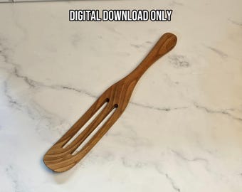 May include: A brown wooden kitchen spatula with a long handle and two vertical slots in the flat head. The text DIGITAL DOWNLOAD ONLY is printed in black above the spatula. The wood grain is visible throughout the surface of the utensil.