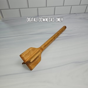 May include: A light brown wooden meat masher with a long handle and a wide, flat, cross-shaped head. The text DIGITAL DOWNLOAD ONLY is printed in black above the object. The wooden tool features a visible grain pattern throughout its surface.